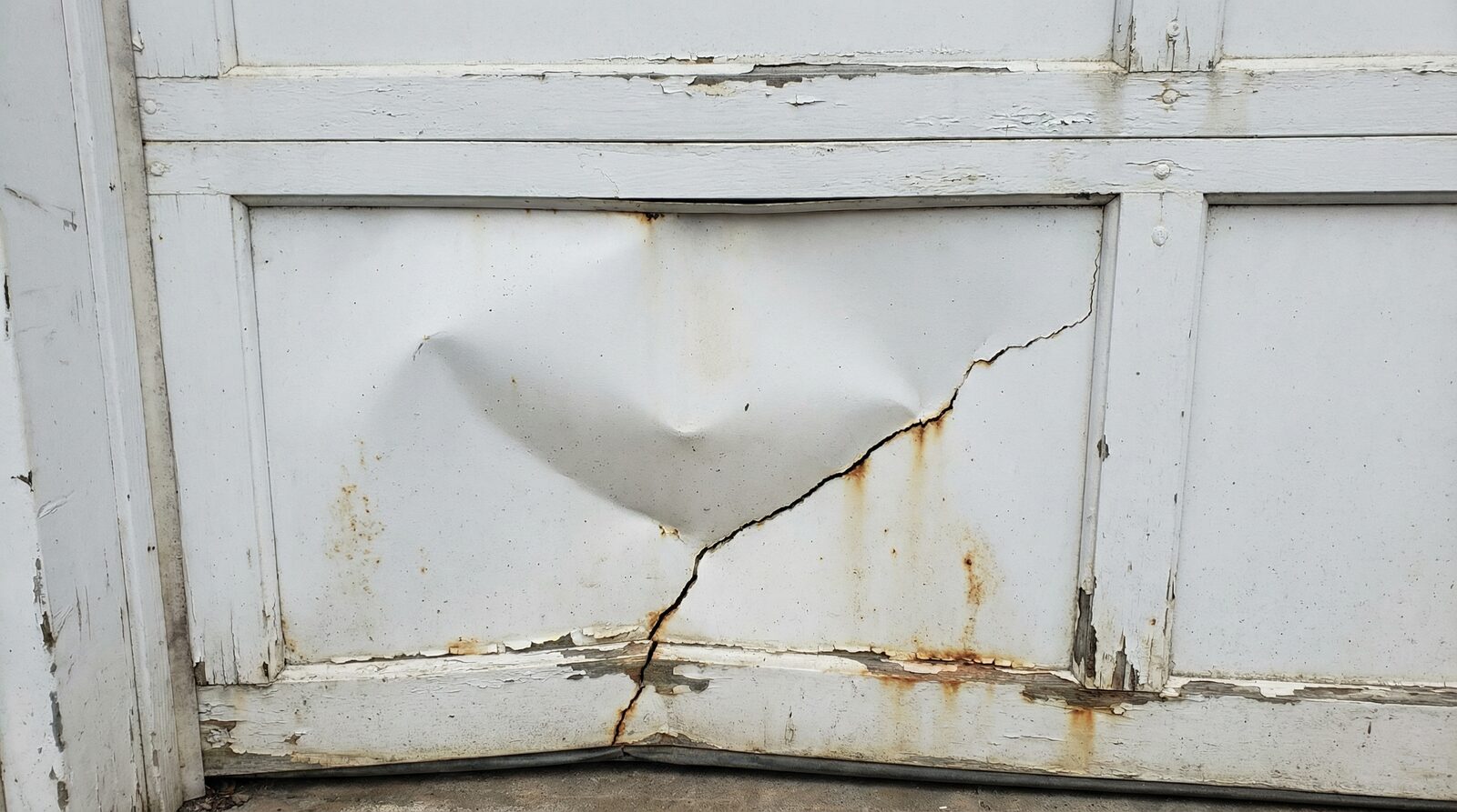 Can You Repair or Replace a Damaged Garage Door Panel? — featured article cover image.