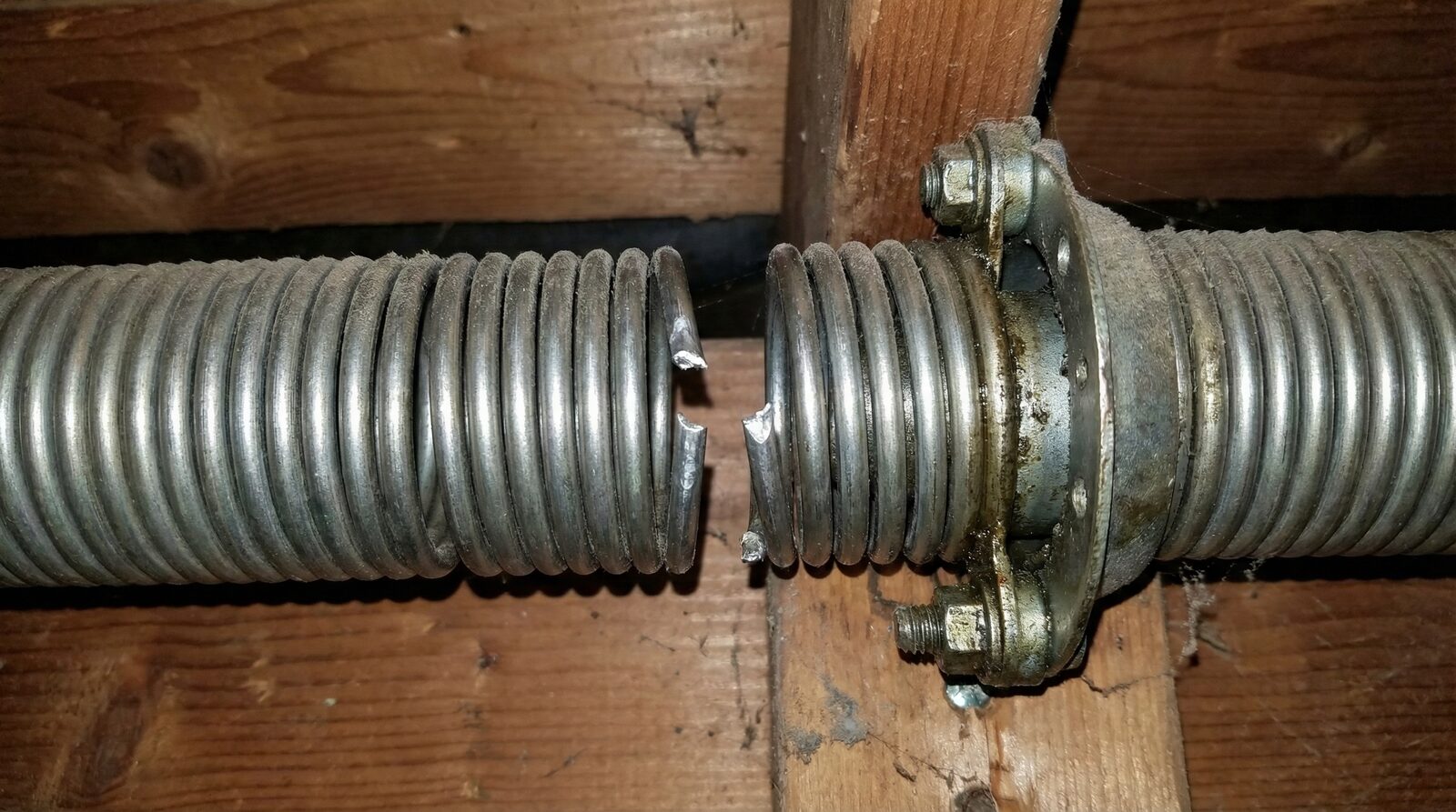 Broken garage door spring requiring professional repair